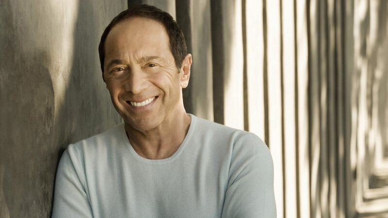 man smiling in light shirt