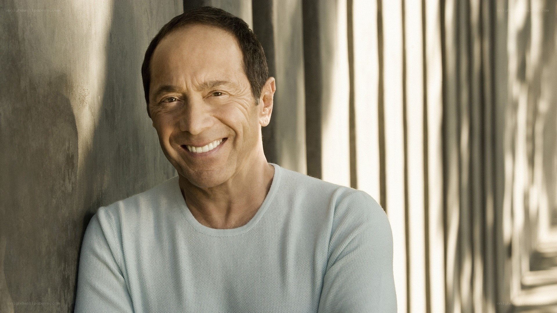 man smiling in light shirt
