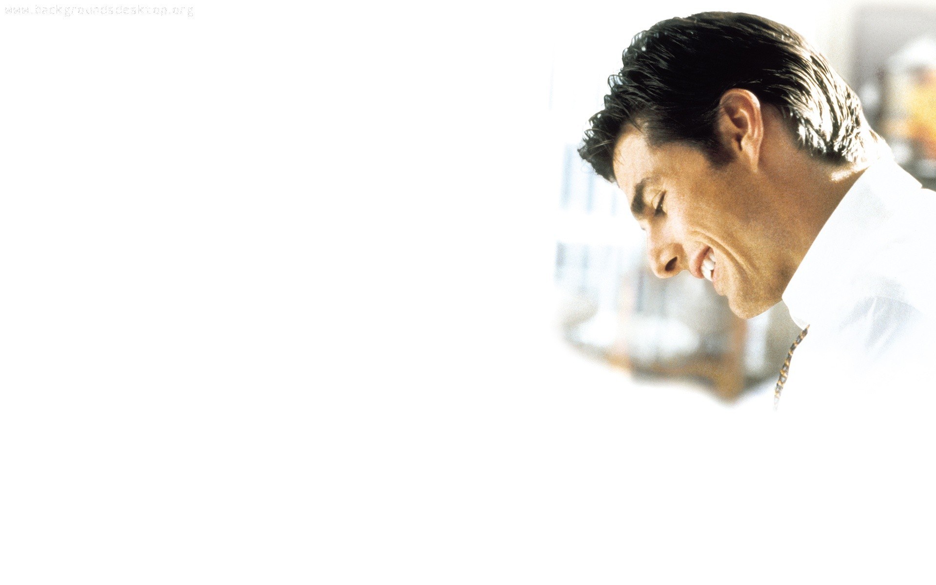 man smiling in white shirt