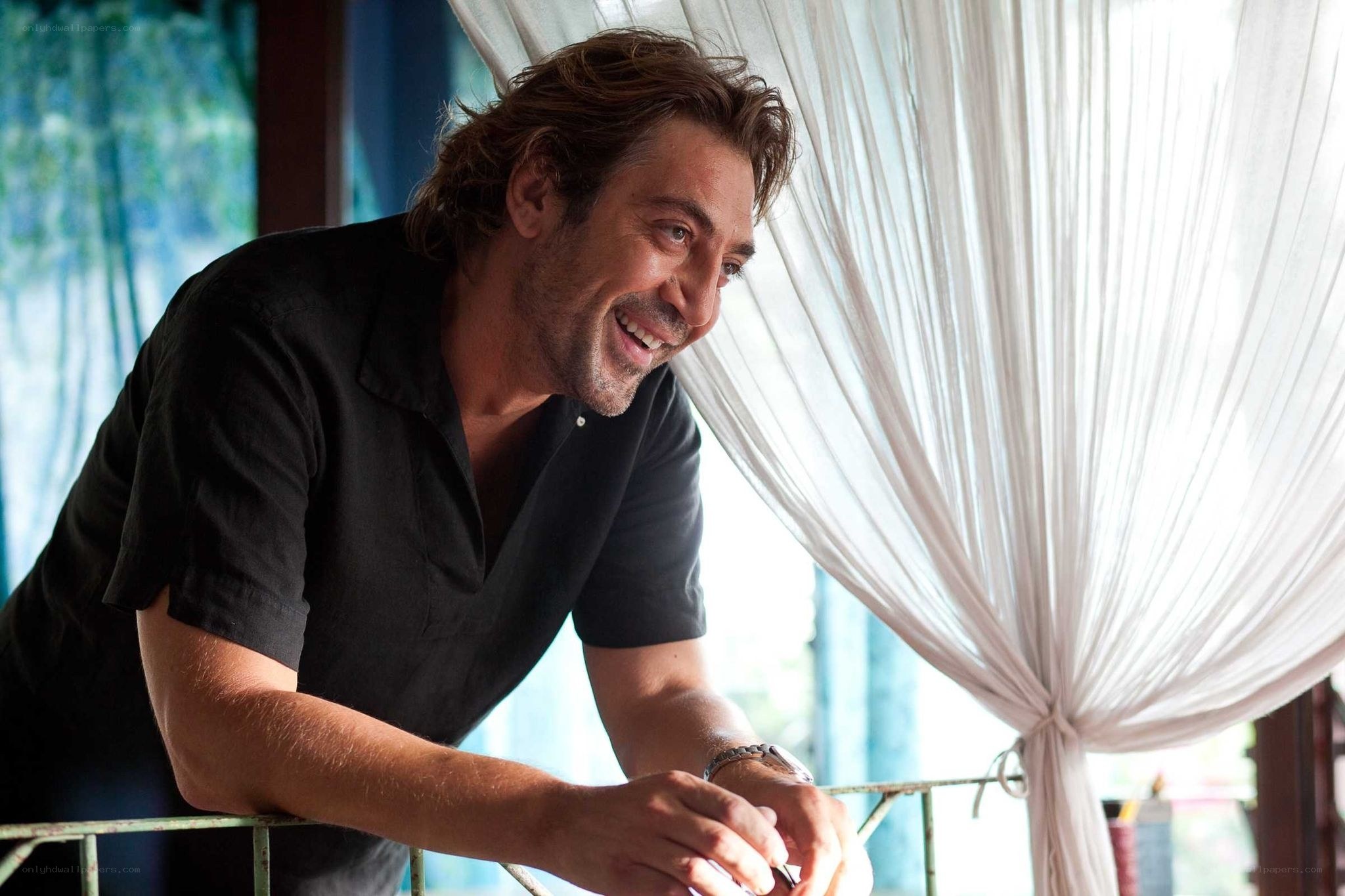 man smiling on balcony