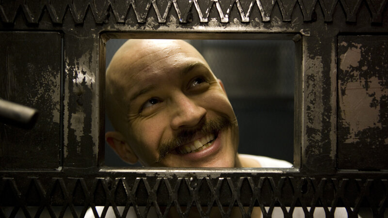 man smiling through prison window