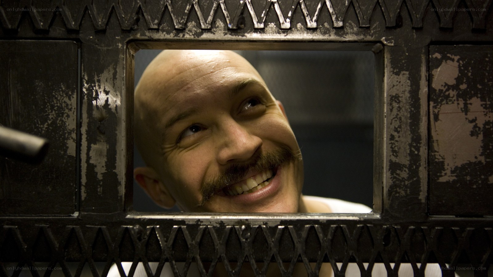 man smiling through prison window