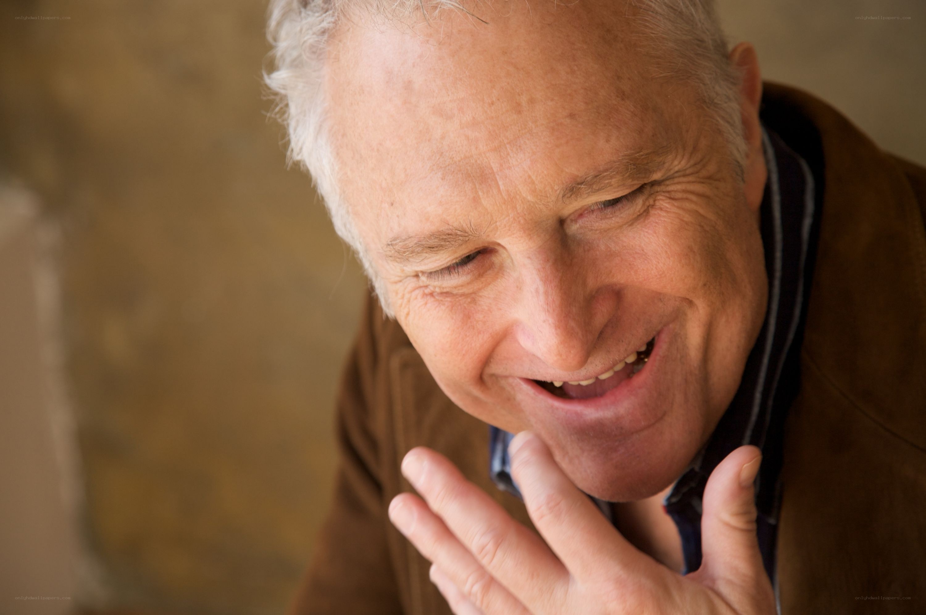 man smiling with hand on chin