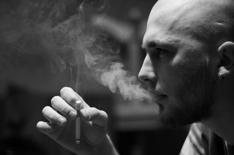 man smoking a cigarette