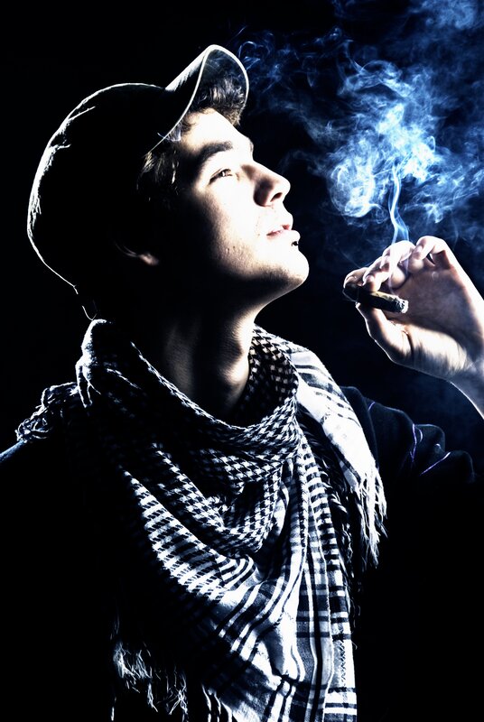 man smoking cigar in dark