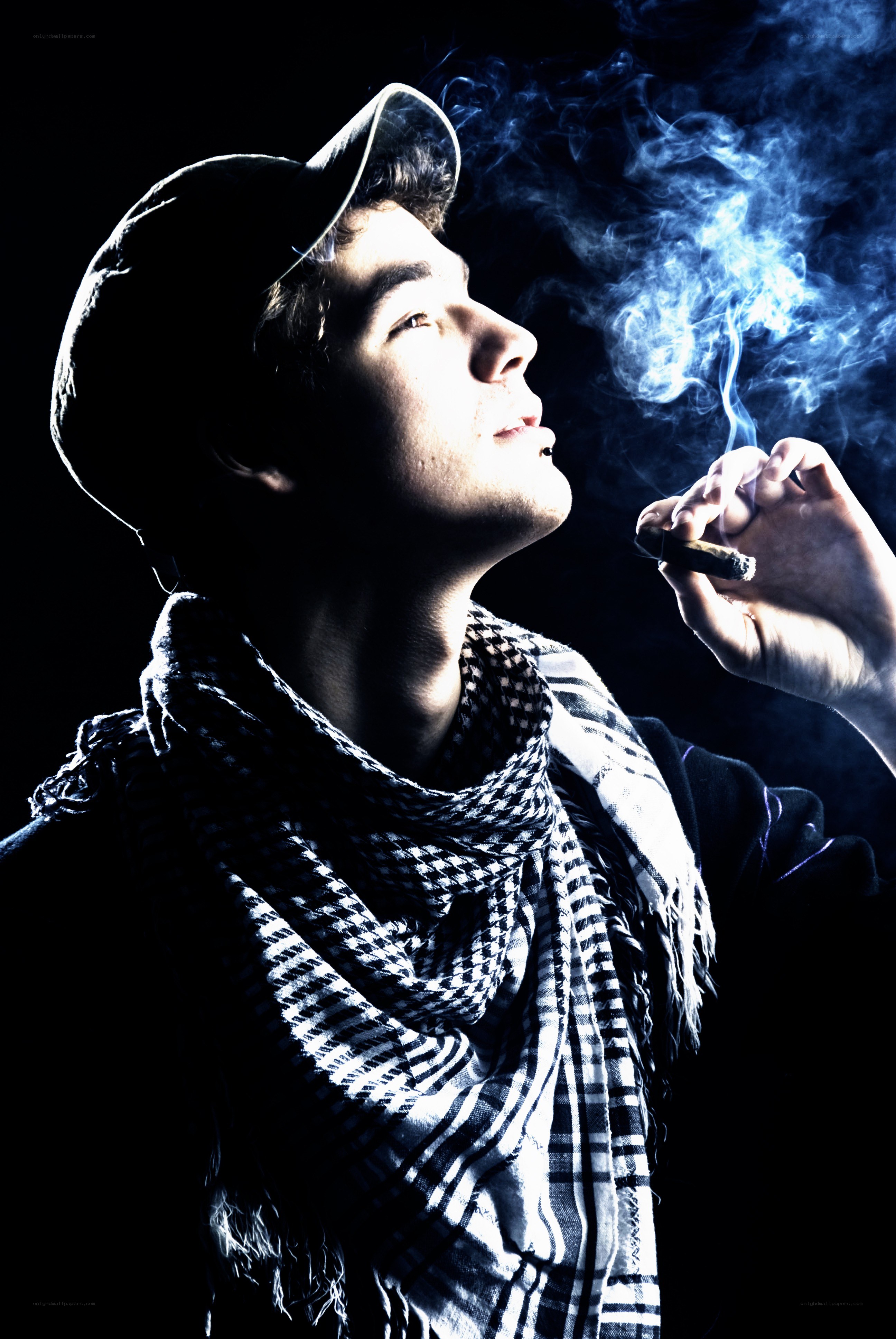 man smoking cigar in dark