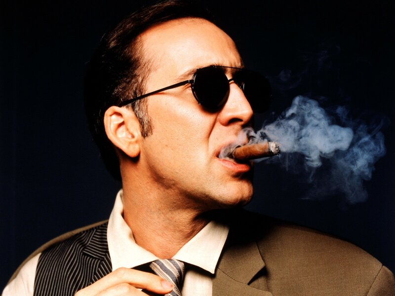 man smoking cigar in suit