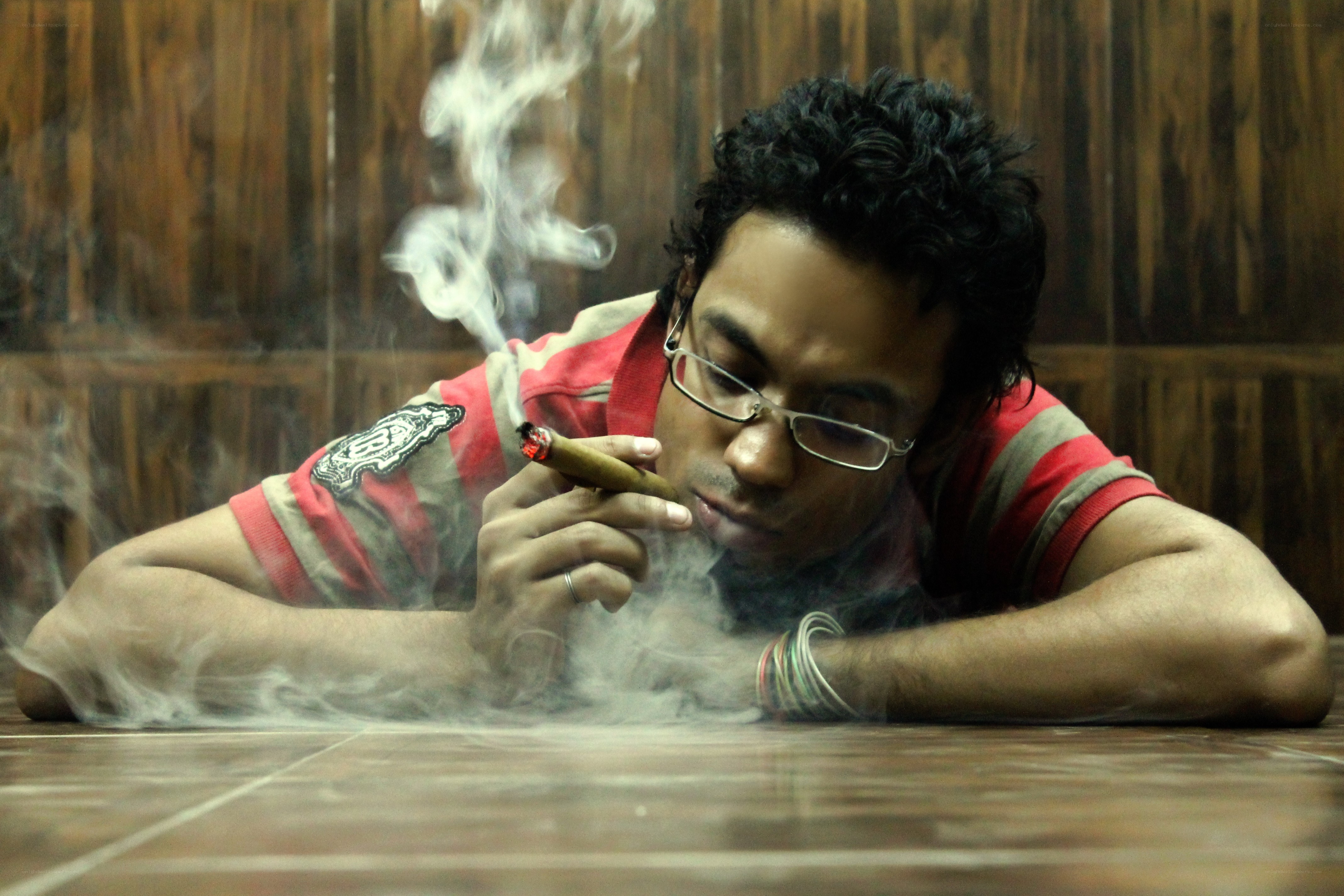 man smoking cigar on floor