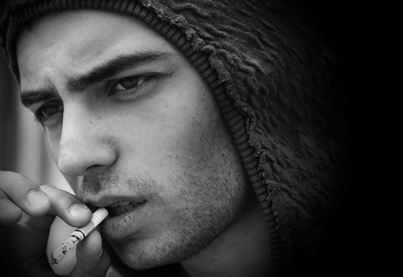 Man Smoking Cigarette — Black, Dramatic, Photograph, Beanie