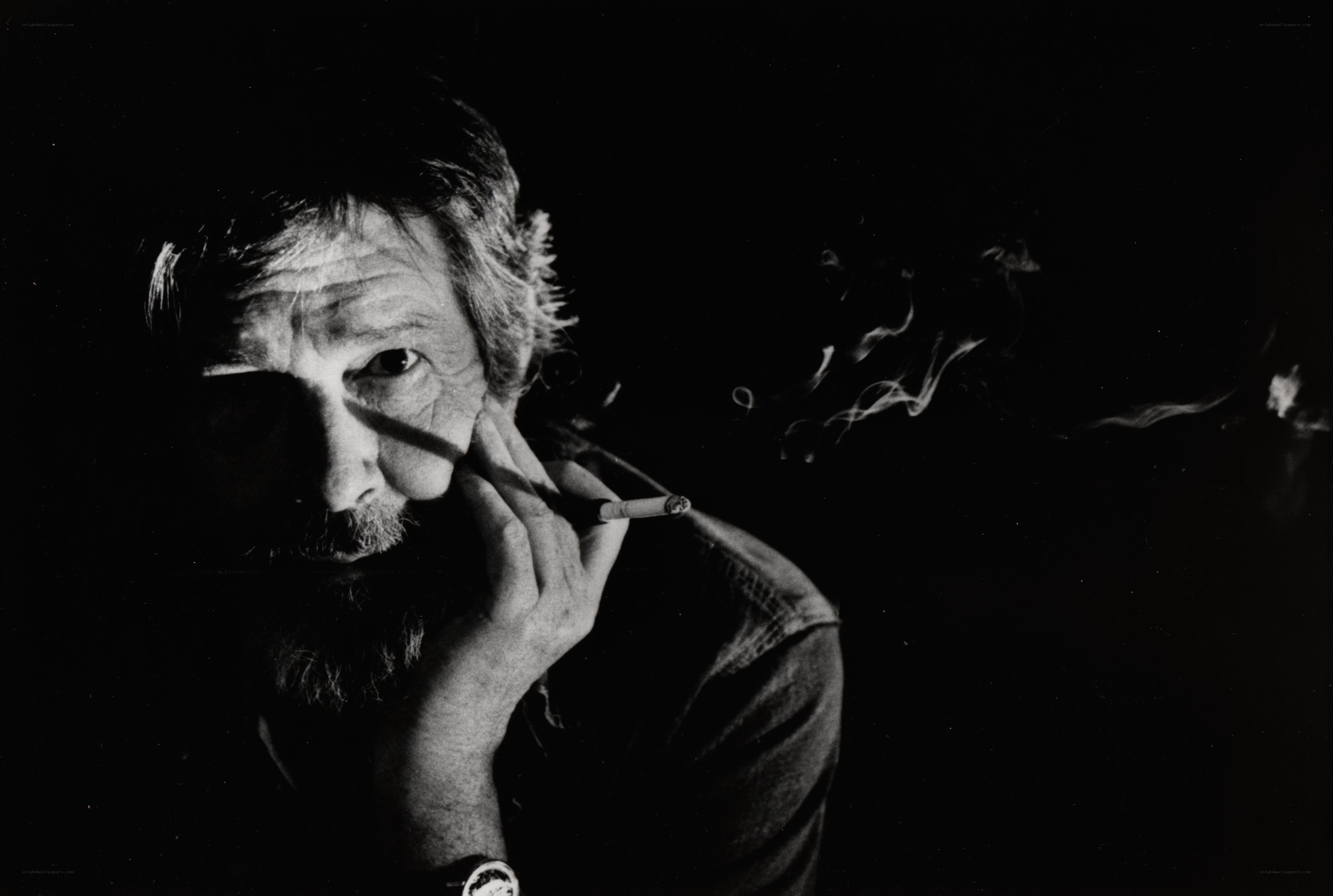 man smoking cigarette in dark