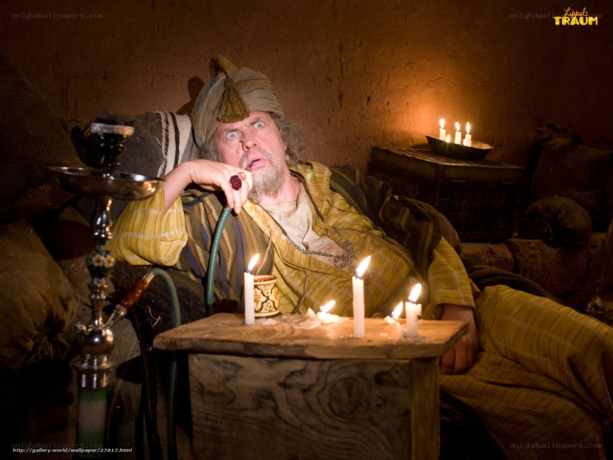 man smoking hookah in candlelight