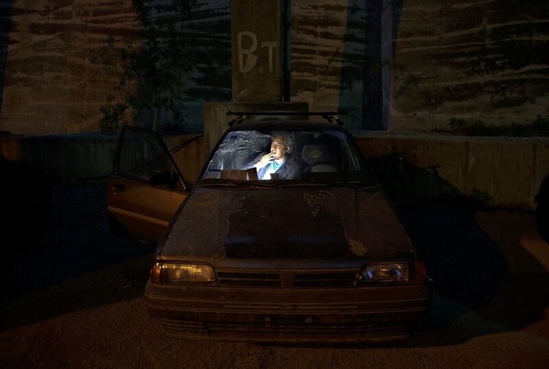 Man smoking in a car at night
