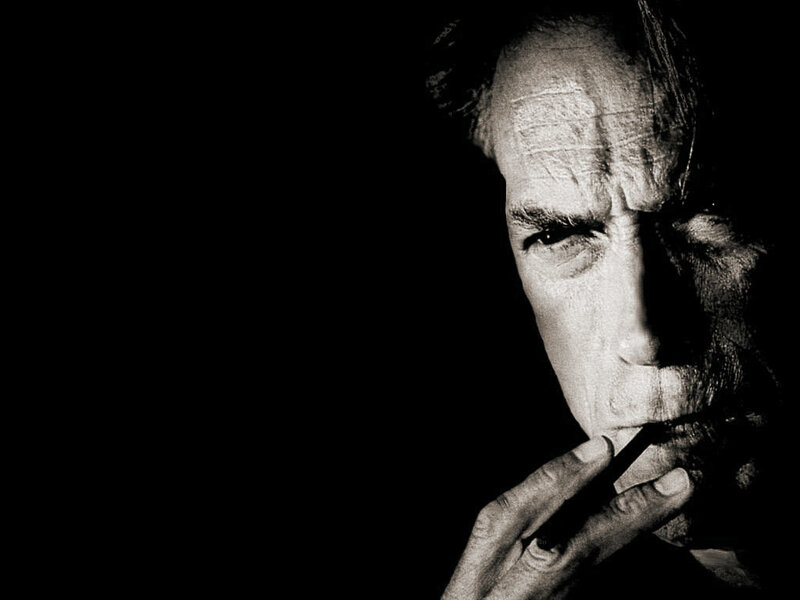 man smoking in black and white