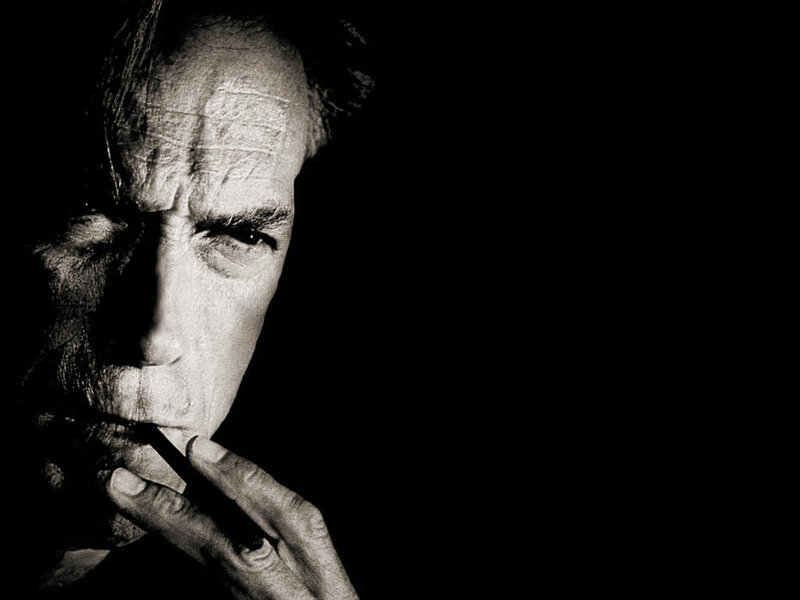 man smoking in black and white