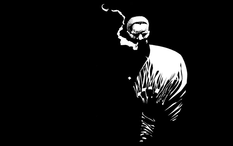 man smoking in black and white