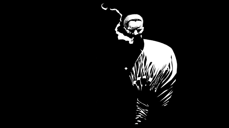 man smoking in black and white