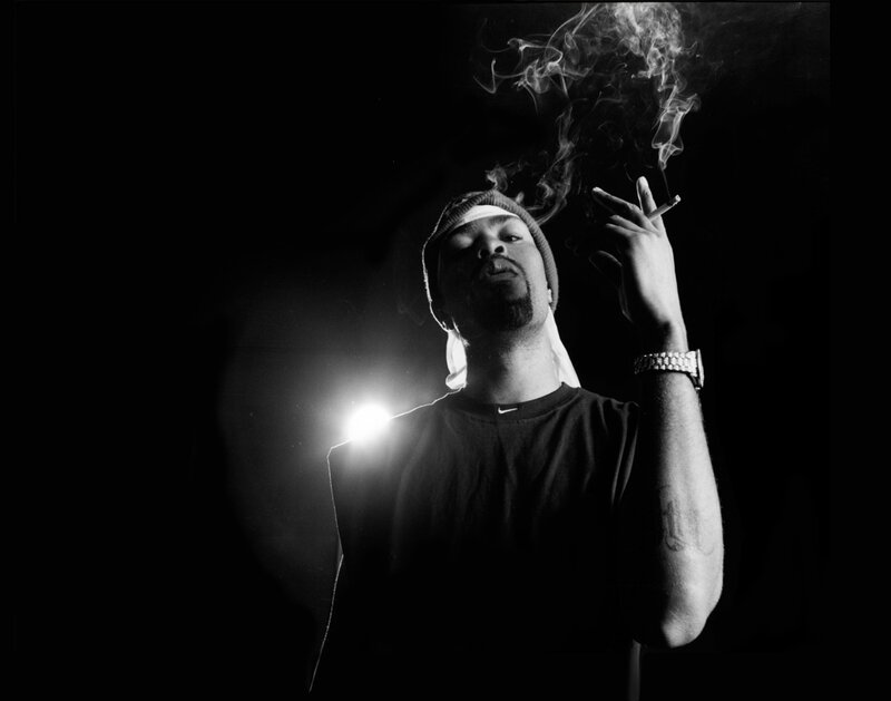 man smoking in black and white