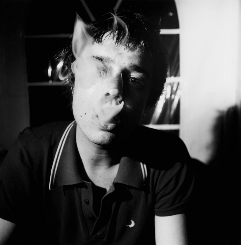 man smoking in black and white