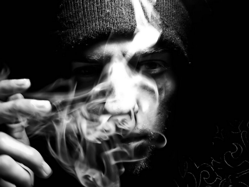 man smoking in black and white