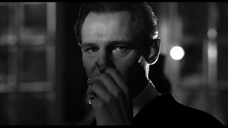 man smoking in black and white
