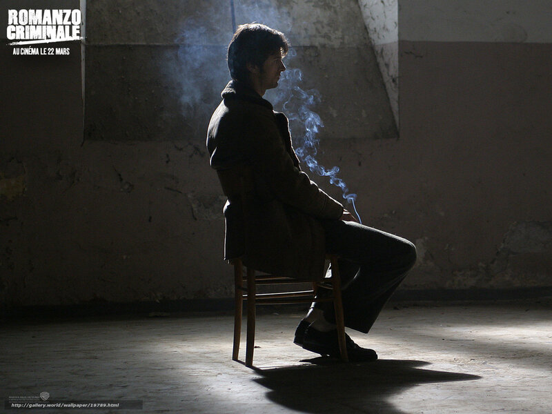 man smoking in dim room