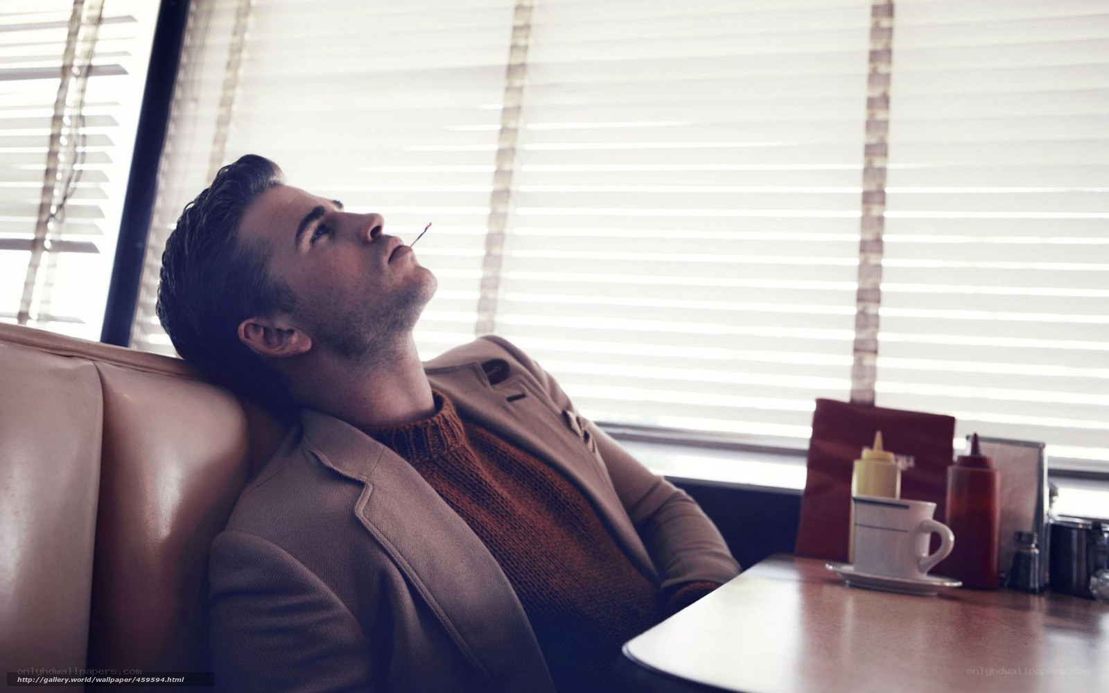 man smoking in diner booth