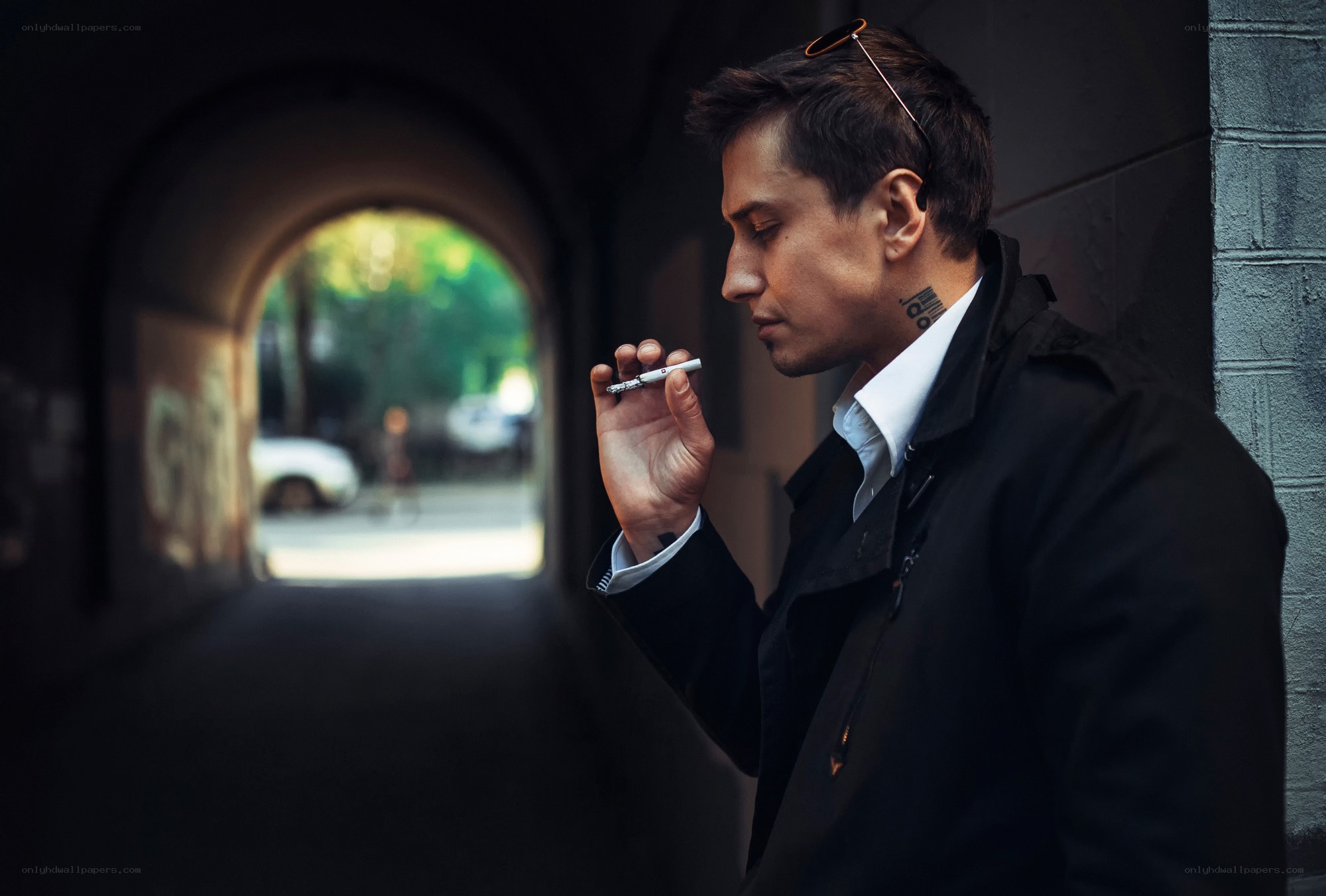 man smoking in tunnel