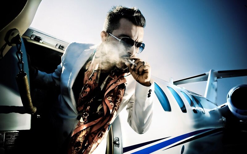 man smoking near private jet