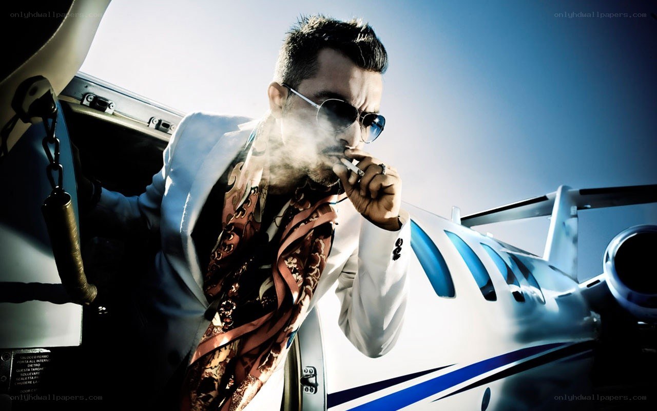 man smoking near private jet