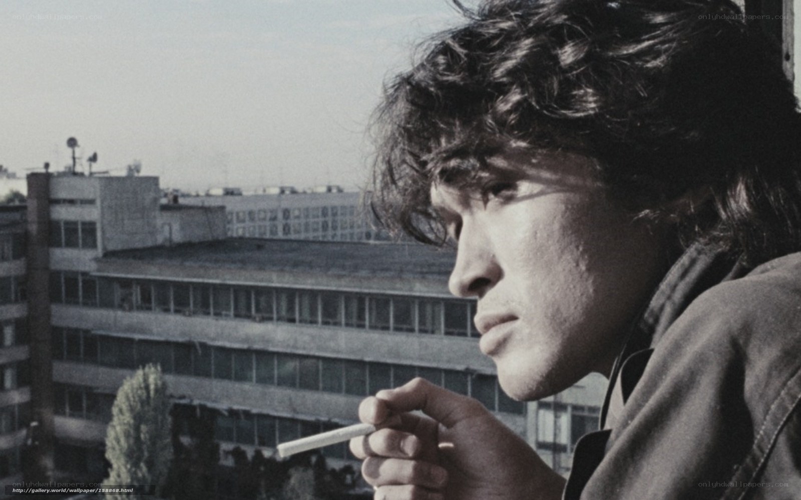 man smoking on balcony