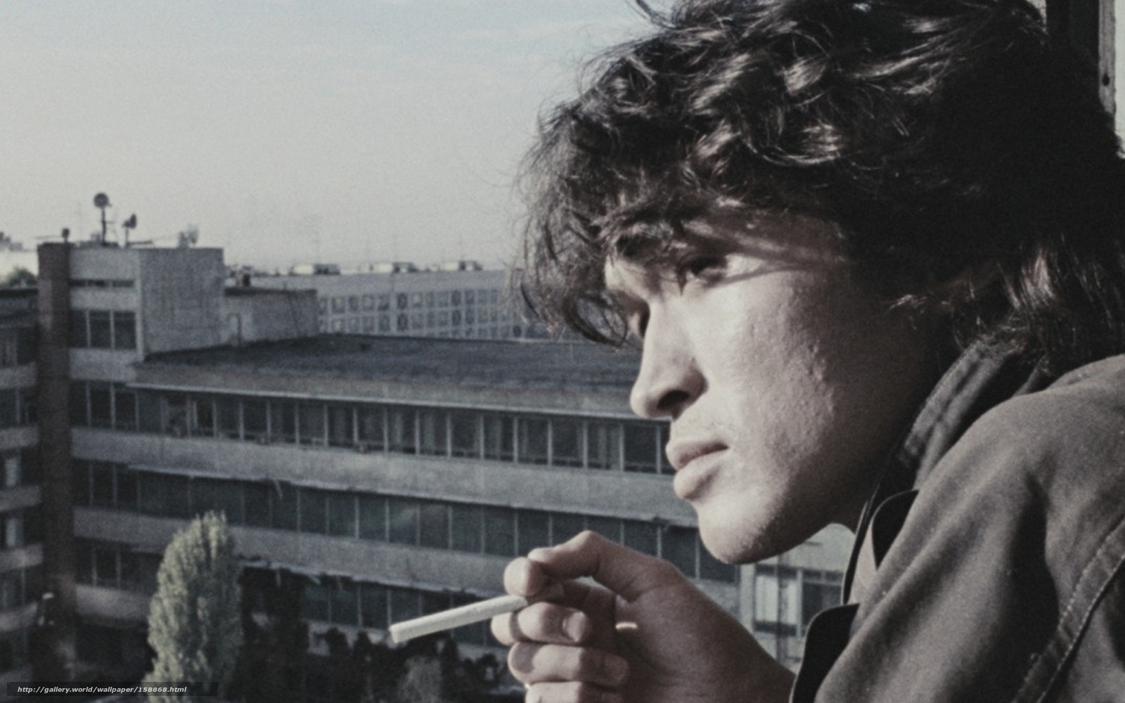 man smoking on balcony