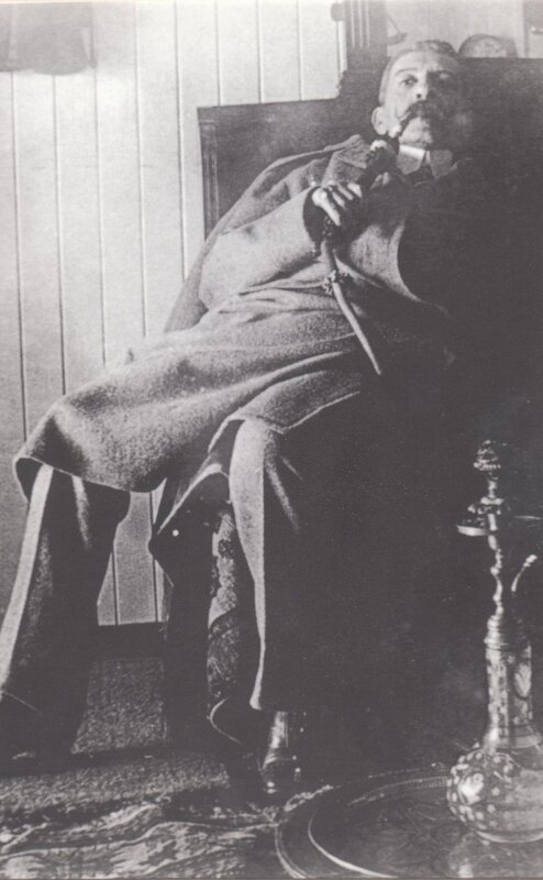 man smoking pipe in chair