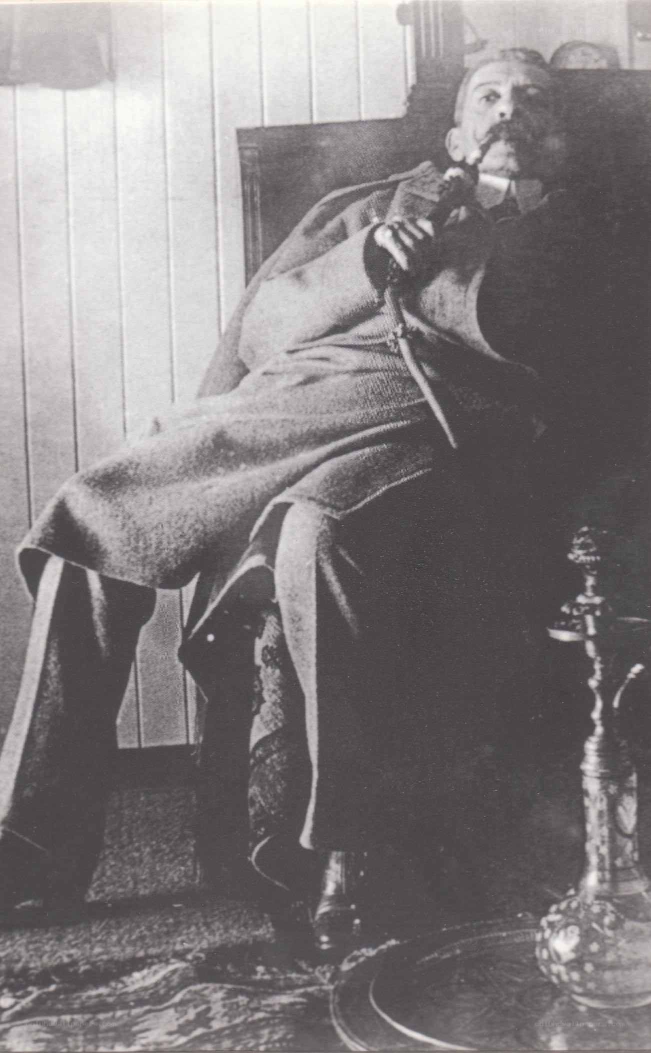 man smoking pipe in chair