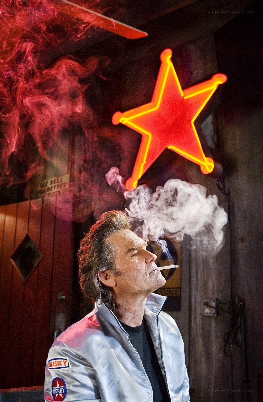 Man smoking under neon star