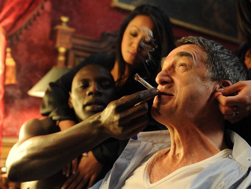 Man smoking with others in room