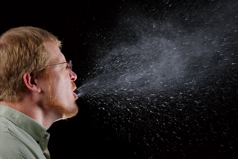 man sneezing in profile