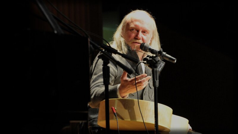Man speaking at a microphone