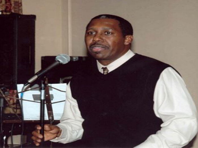 Man Speaking at Microphone — Black