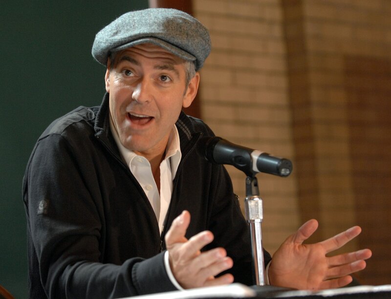 Man Speaking at Microphone — Gray