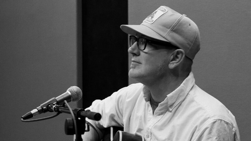 man speaking at microphone