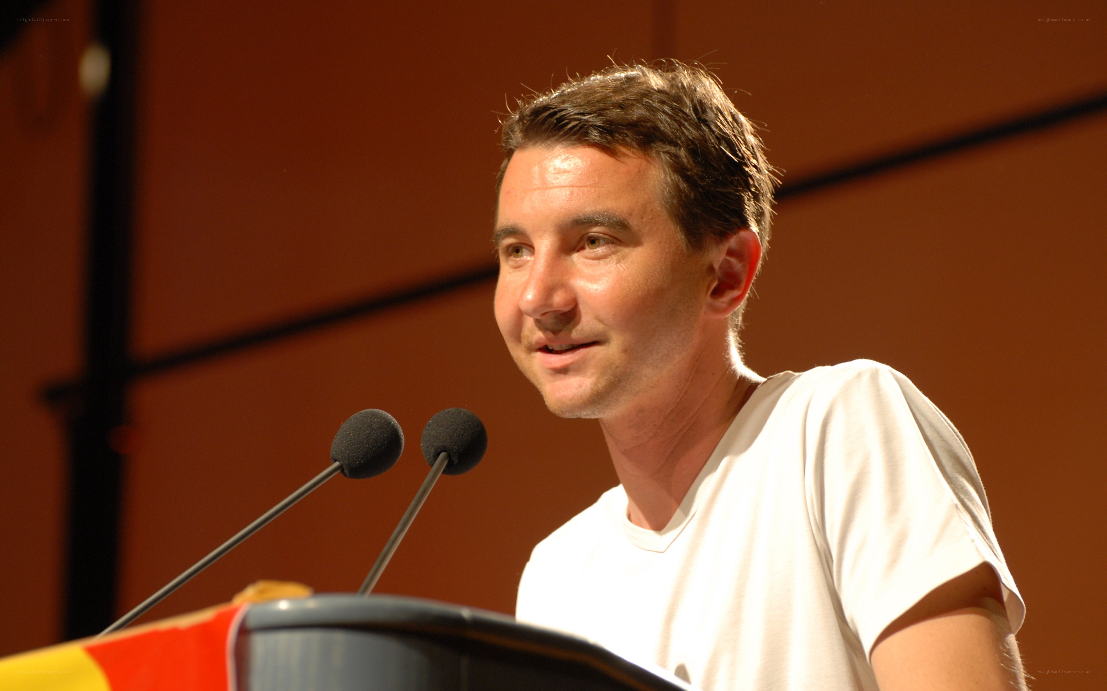 man speaking at podium