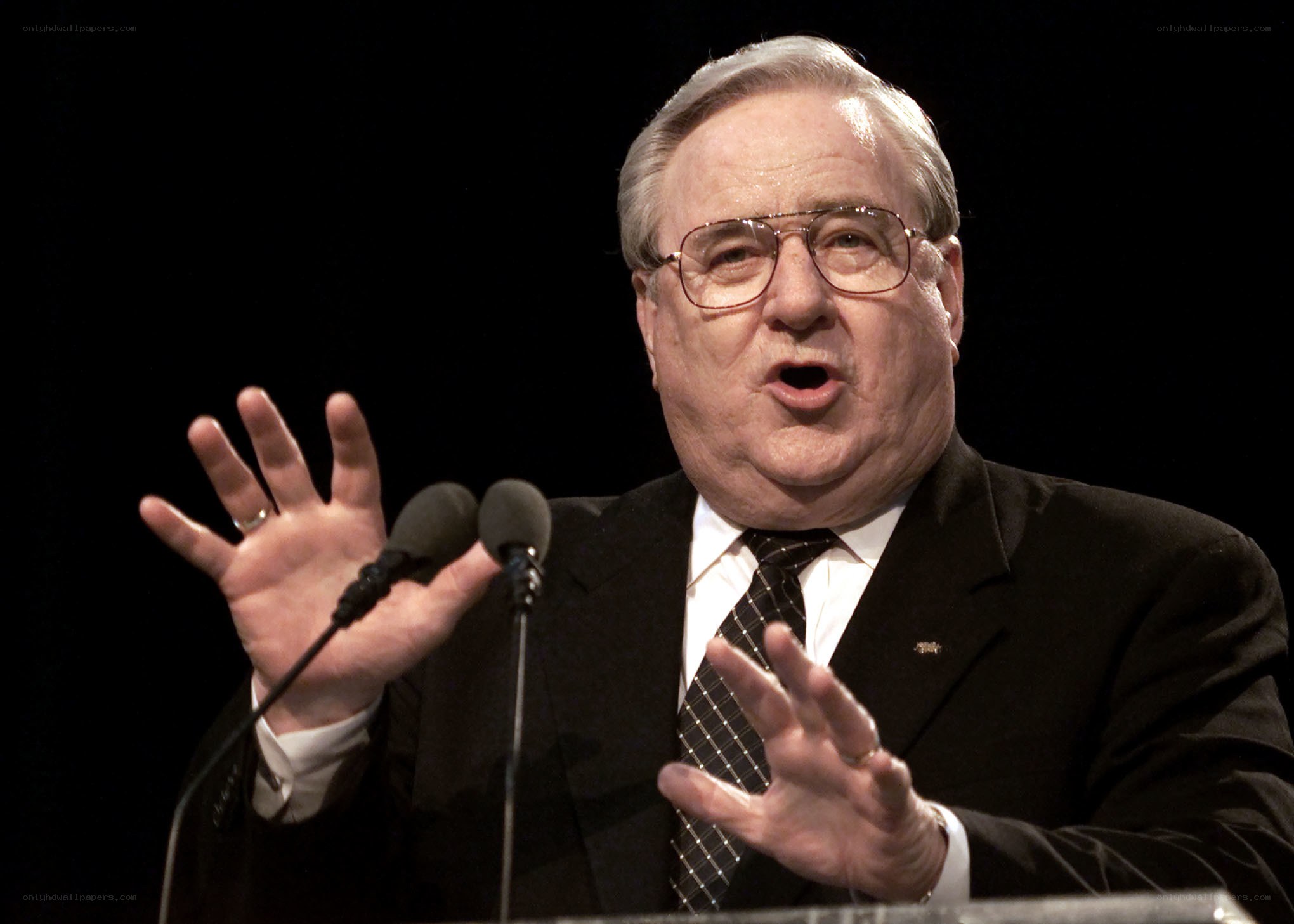 man speaking at podium