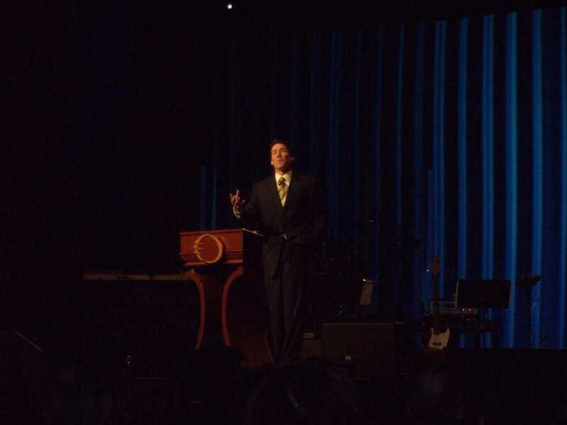 Man Speaking at Podium — Black