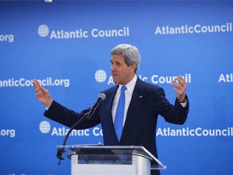 Man Speaking at Podium — Blue, Formal, Photograph, Microphone, Blue Background