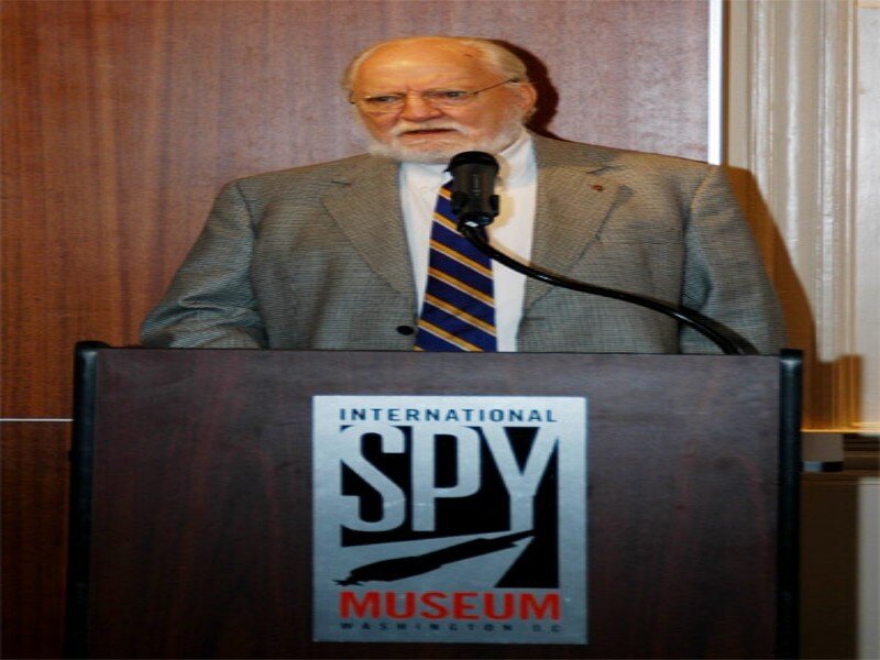 Man Speaking at Podium — Brown