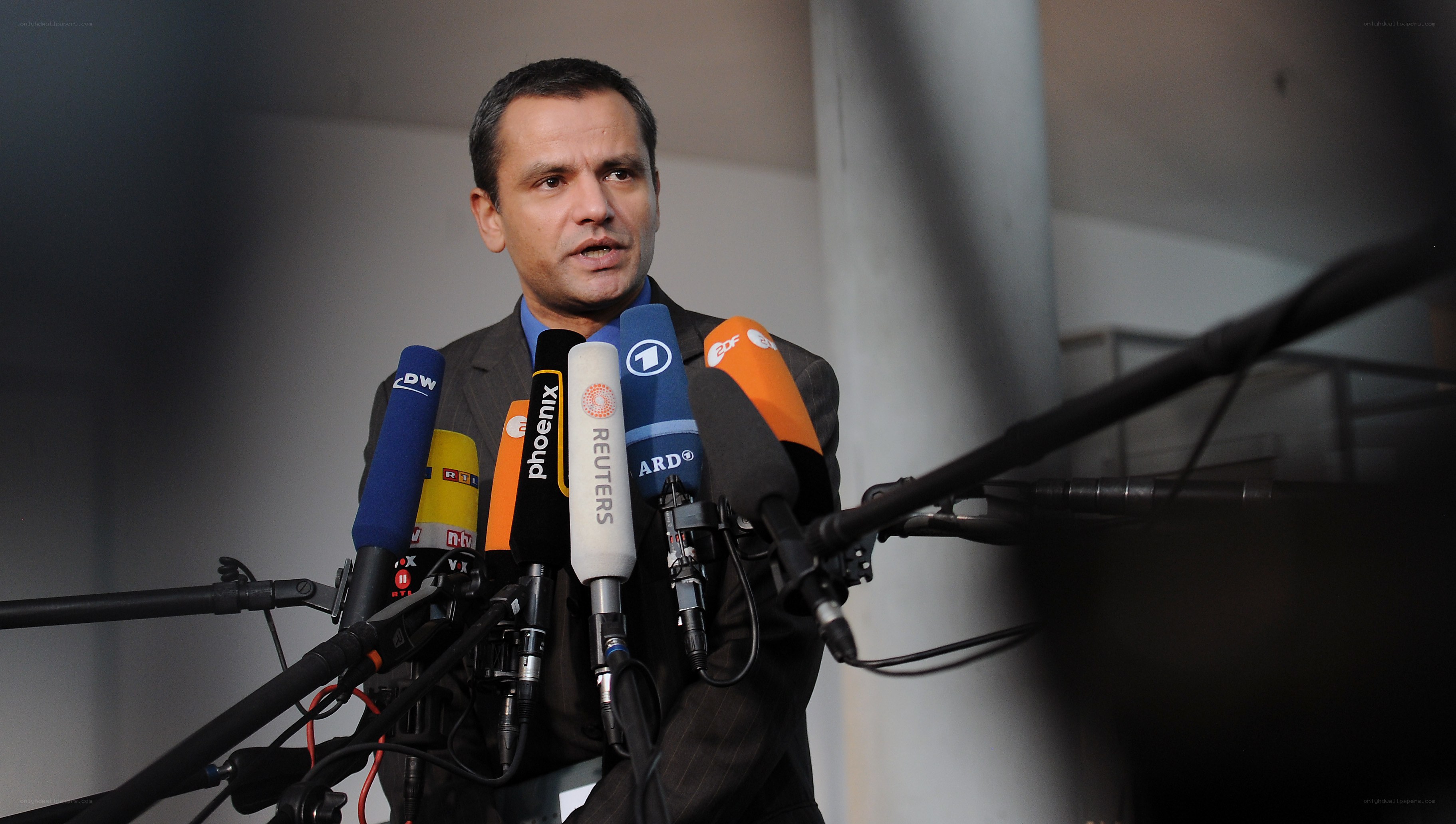 man speaking at press conference