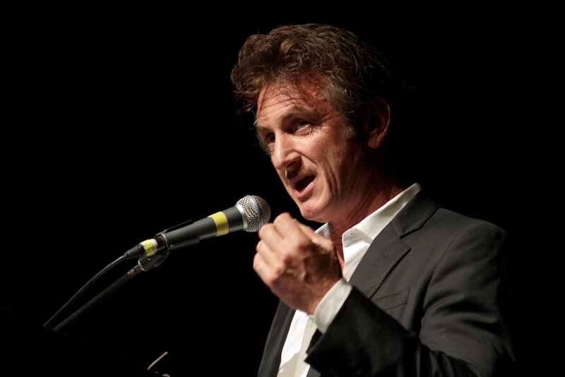 Man Speaking into Microphone — Black, Dramatic, Photograph