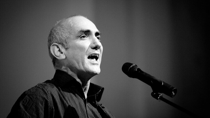 Man Speaking into Microphone — Black, Dramatic