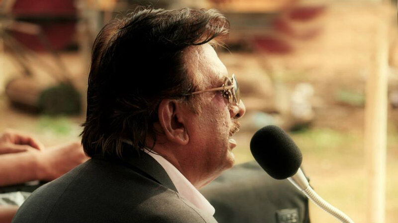 Man Speaking into Microphone — Brown