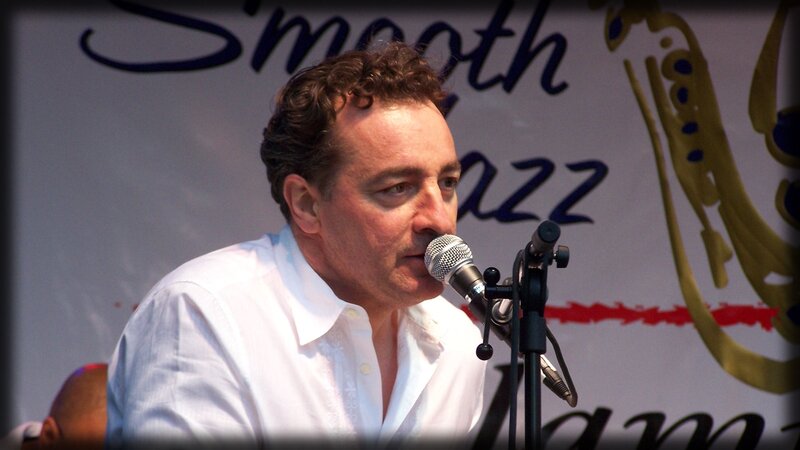 Man Speaking into Microphone — White, Performing